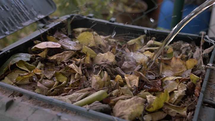 Zalévání listí v kompostéru.