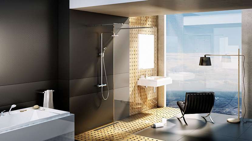 Průchozí sprchovací kout za skleněnou zástěnou, která chrání okolí před nežádoucí vodou.
