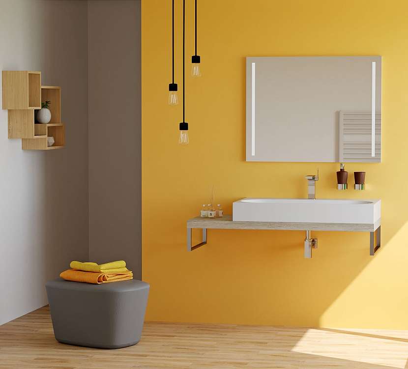 Umyvadlo KUBE usazené na umyvadlové desce na míru působí harmonicky i ve výrazně žlutém interiéru.